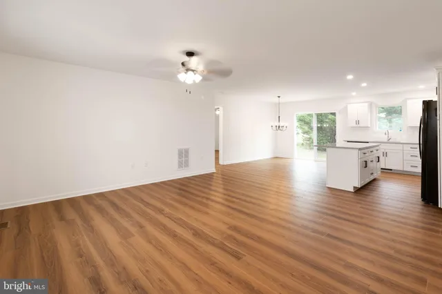 a view of a kitchen with a dishwasher cabinets and wooden floor