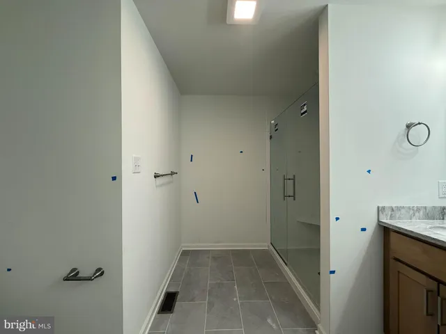 a bathroom with a granite countertop sink a mirror and a