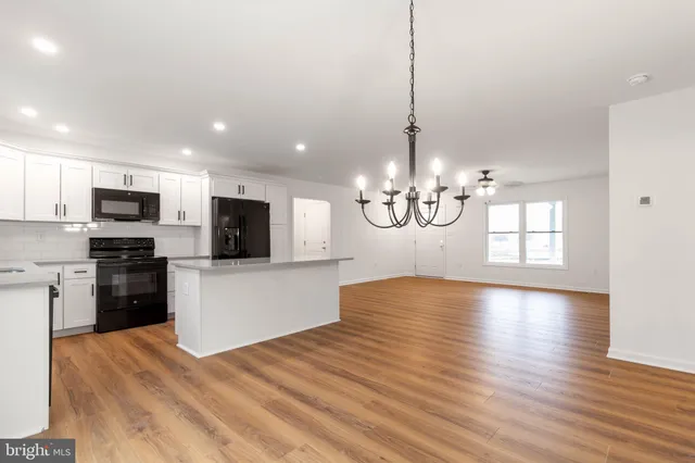 a view of a kitchen with microwave and cabinets