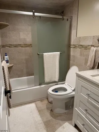 a white toilet sitting next to a bath tub