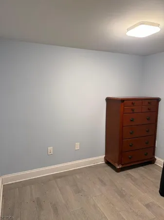 an empty room with a dresser