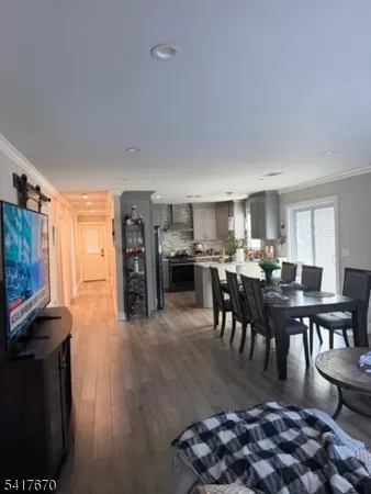 a living room with furniture a dining table and kitchen view