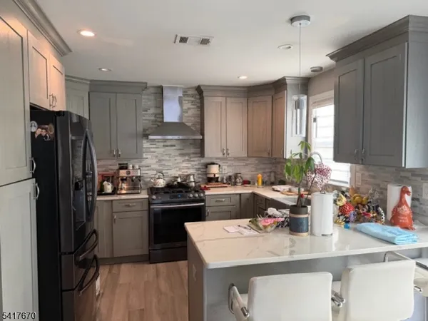 a kitchen with refrigerator and cabinets