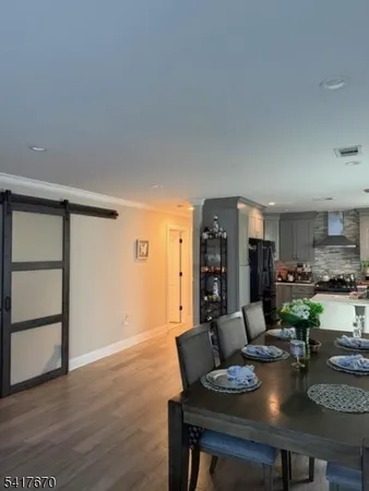 a dining room with furniture and wooden floor
