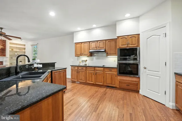 a living room with furniture and floor to ceiling windows