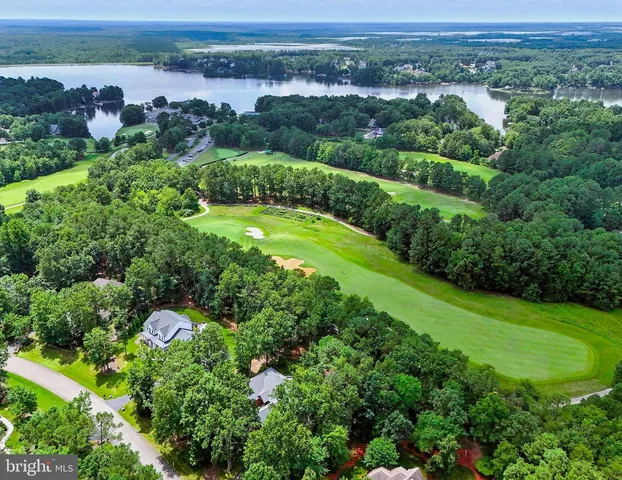 a front view of a house with a yard and fountain