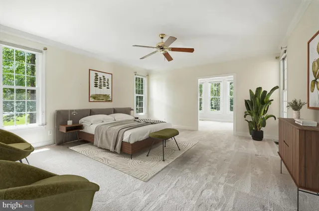 a view of empty room with window and ceiling fan