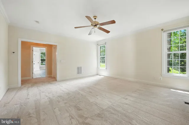 a bathroom with a tub double sink window and mirror