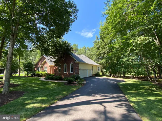a backyard of a house with a yard and outdoor seating