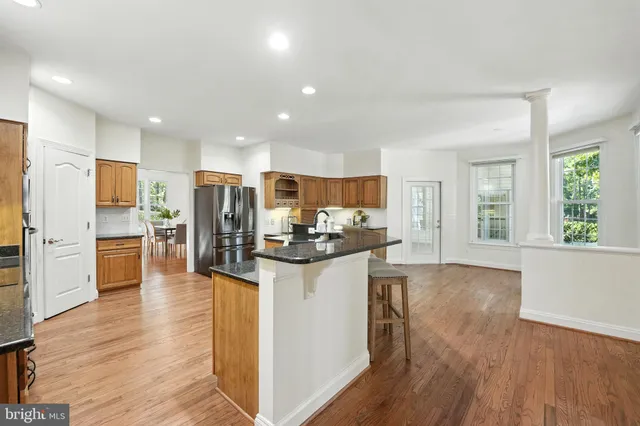 a kitchen with stainless steel appliances granite countertop a refrigerator and a stove top oven