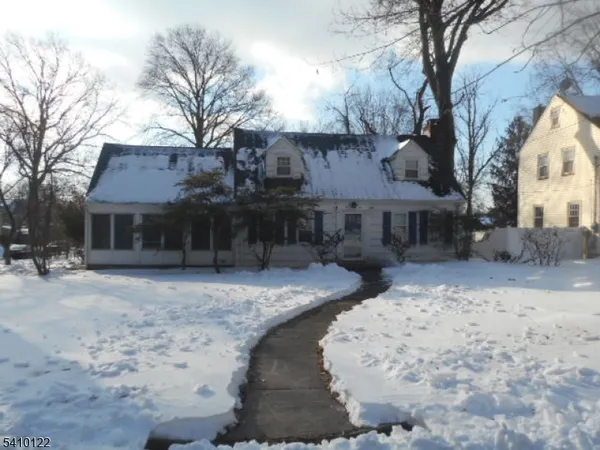 a view of a house with a yard covered in snow