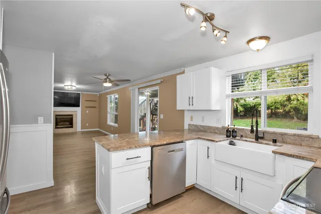 a view of a hallway with wooden floor and a living room