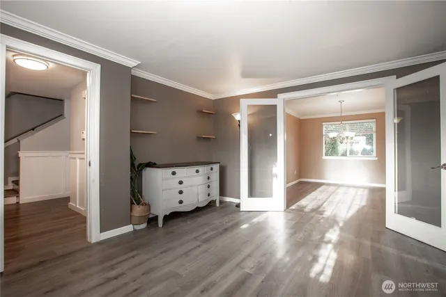 a view of an empty room with a fireplace and a window