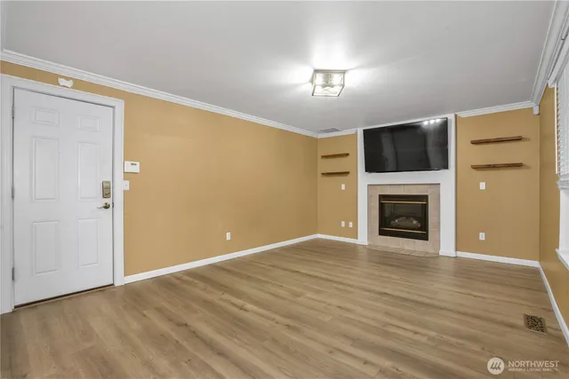 a view of a livingroom with a chandelier fan and a window