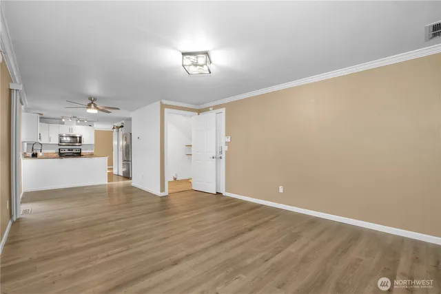 a view of a kitchen with wooden floor and a kitchen