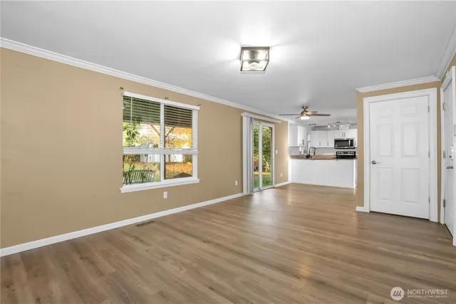 a kitchen with stainless steel appliances granite countertop a sink a stove and a microwave