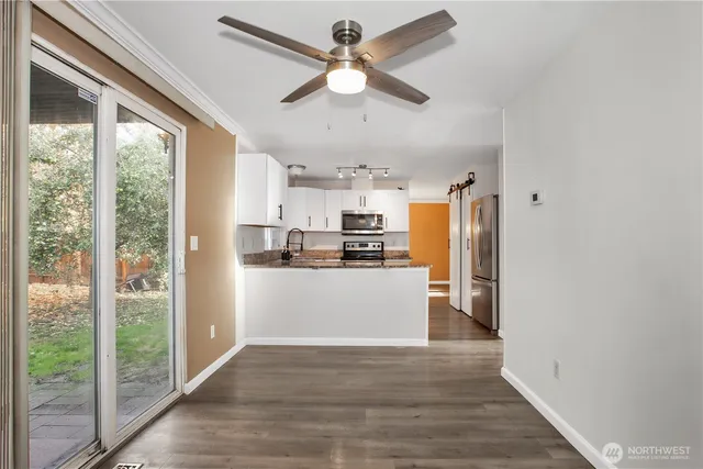 a kitchen with stainless steel appliances granite countertop a refrigerator and a sink