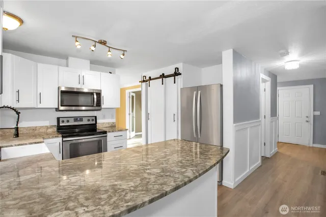 a view of a room with a window and wooden floor
