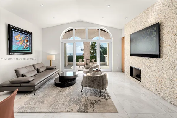 a living room with fireplace furniture and a flat screen tv