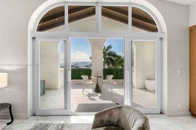 a bedroom with a balcony a bed and a glass door