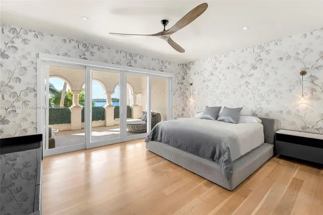 a spacious bedroom with a large bed and a large window