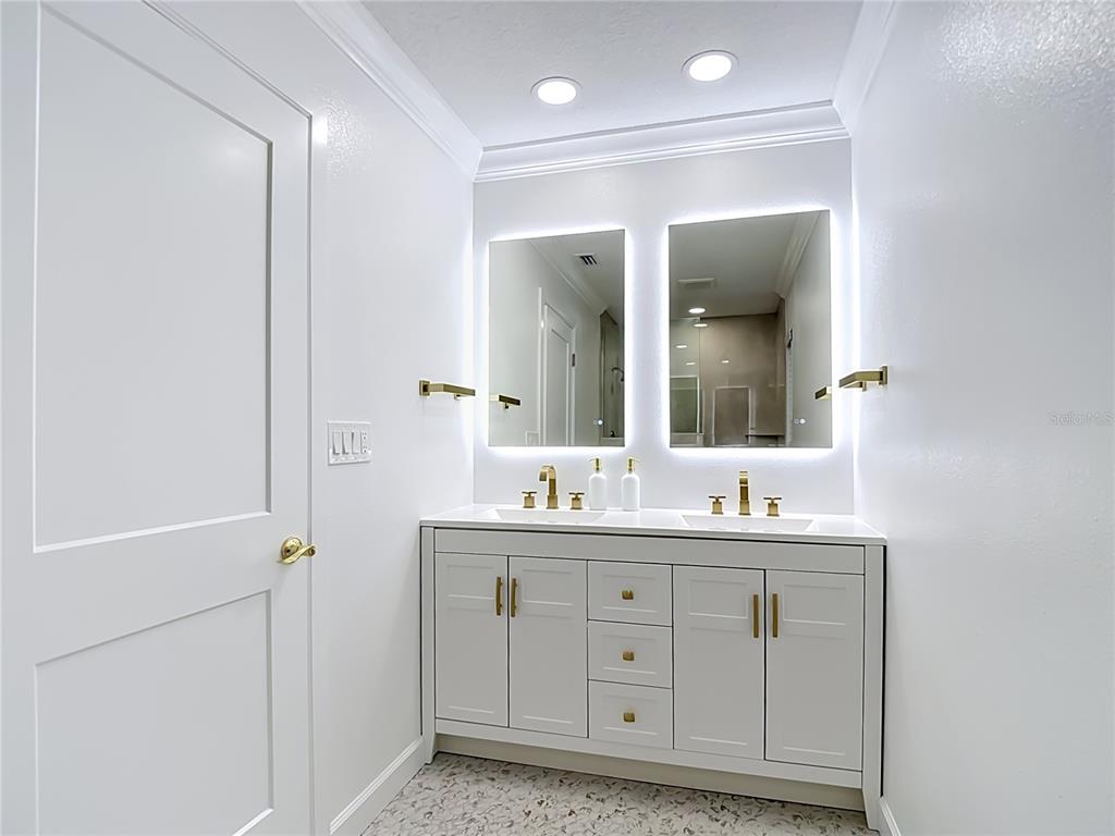 4536 Mitcher Road New Port Richey, FL 34652 - Photo 12 of 46 a bathroom with a double vanity sink and mirror