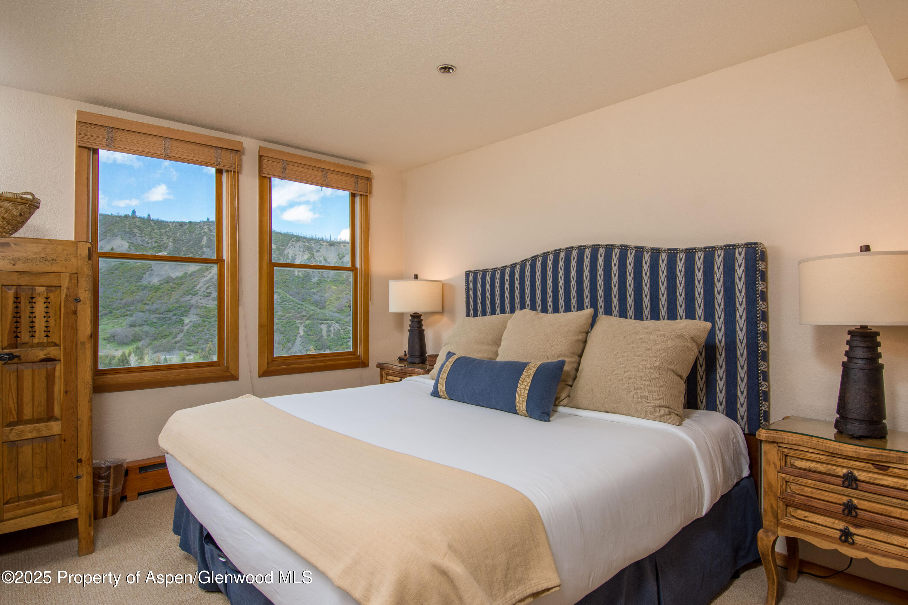425 Wood Road, Unit 48 Snowmass Village, CO 81615 - Photo 25 of 41 a bedroom with a bed and window
