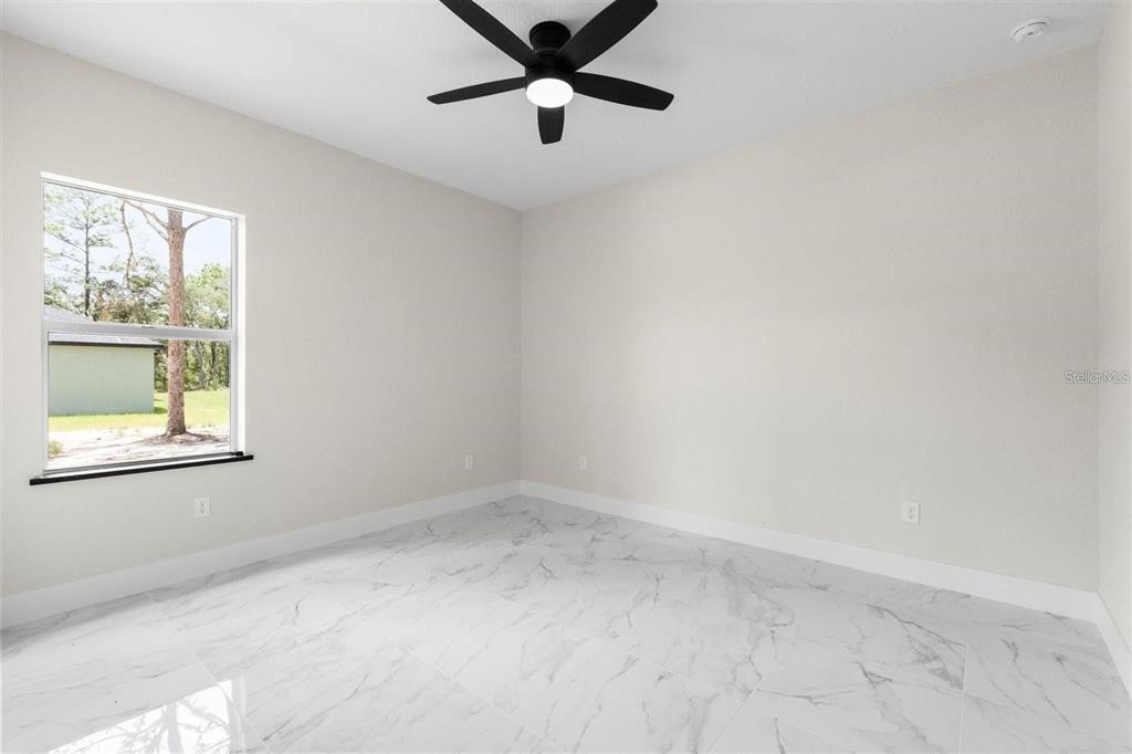 13619 Southwest 78th Place Dunnellon, FL 34432 - Photo 17 of 31 an empty room with a window and a fan