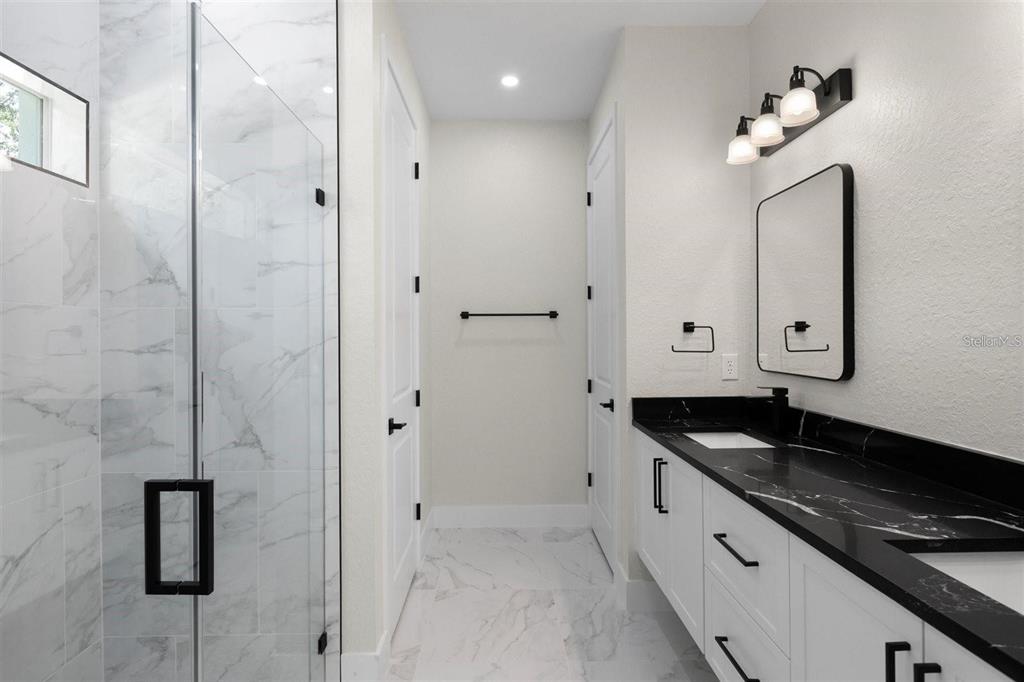 13619 Southwest 78th Place Dunnellon, FL 34432 - Photo 18 of 31 a spacious bathroom with a granite countertop sink a mirror and shower