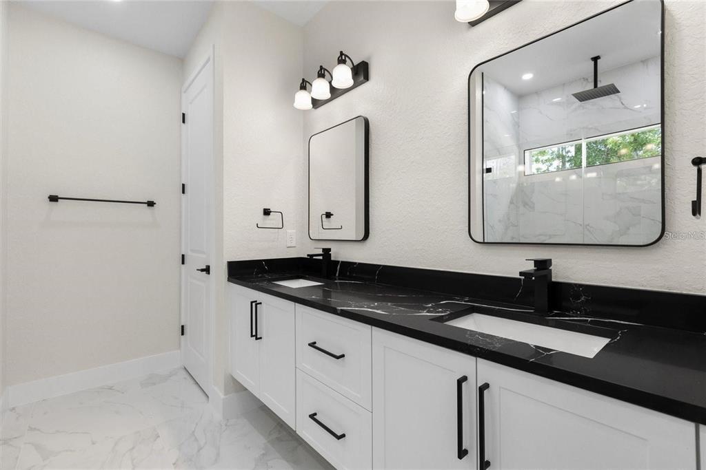13619 Southwest 78th Place Dunnellon, FL 34432 - Photo 19 of 31 a bathroom with a granite countertop sink a mirror and vanity