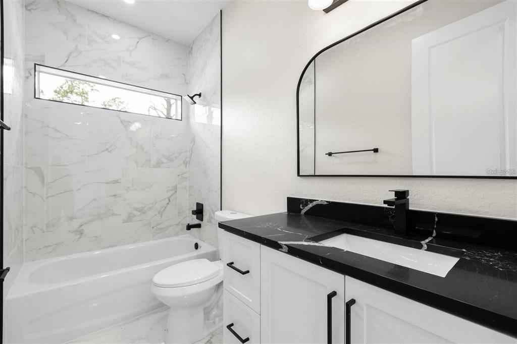 13619 Southwest 78th Place Dunnellon, FL 34432 - Photo 23 of 31 a bathroom with a sink a toilet and a mirror