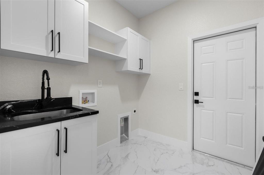 13619 Southwest 78th Place Dunnellon, FL 34432 - Photo 24 of 31 a kitchen with white cabinets and a stove