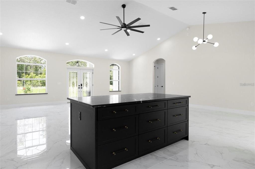 13619 Southwest 78th Place Dunnellon, FL 34432 - Photo 7 of 31 a kitchen with a sink chandelier and a window