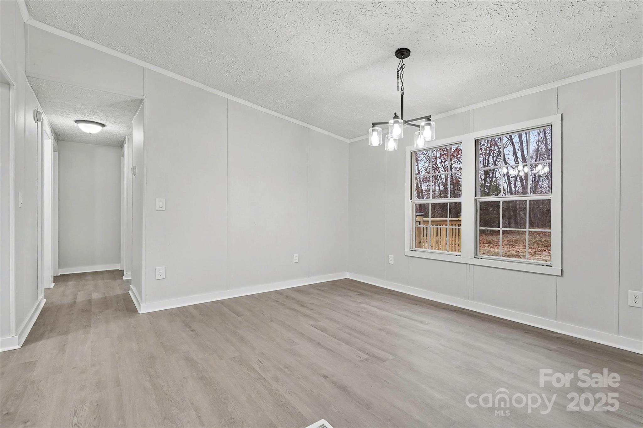 115 Lakeview Lane China Grove, NC 28023 - Photo 14 of 32 en empty room with windows and chandelier