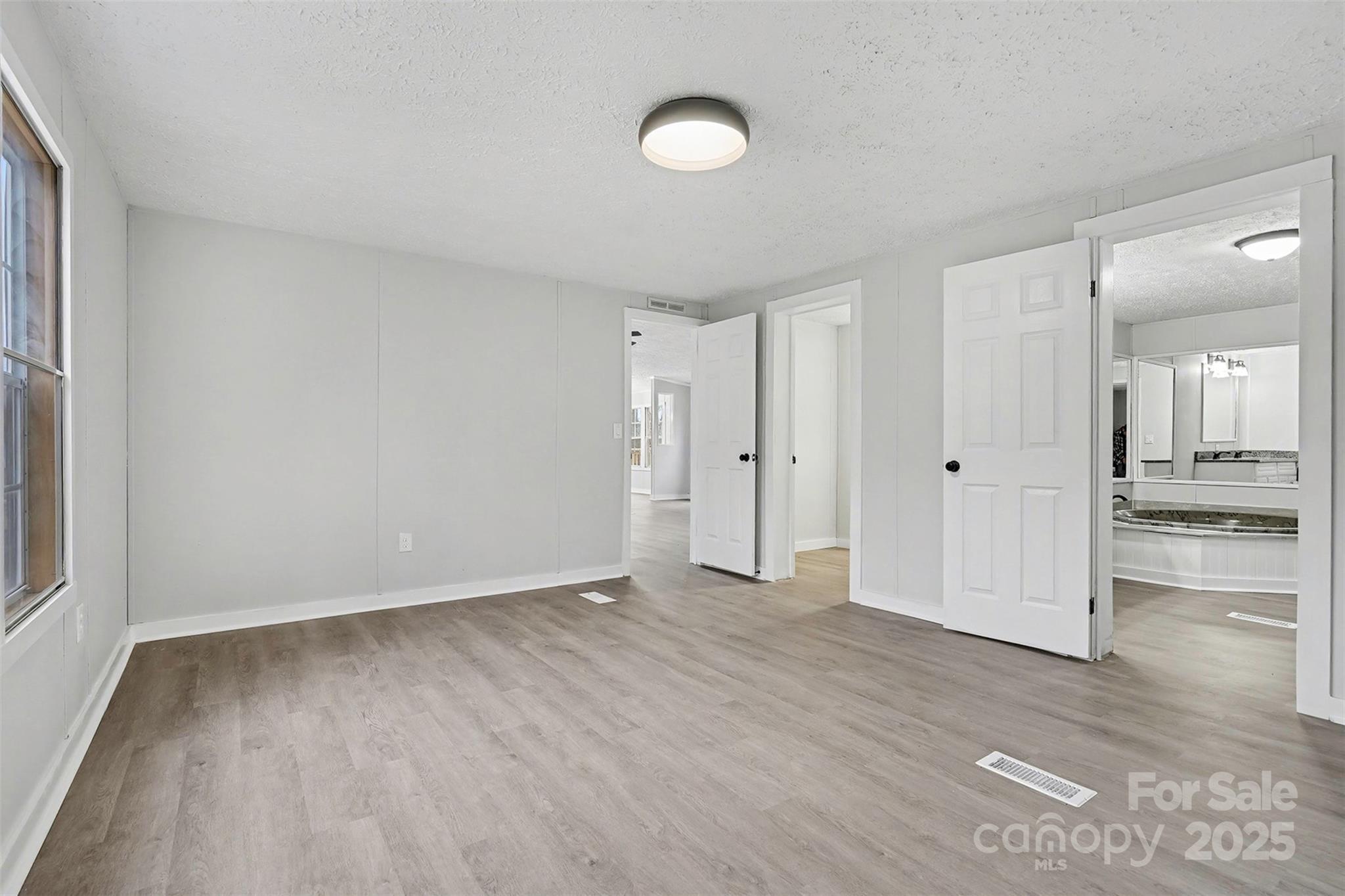 115 Lakeview Lane China Grove, NC 28023 - Photo 17 of 32 a view of an empty room with wooden floor and a window