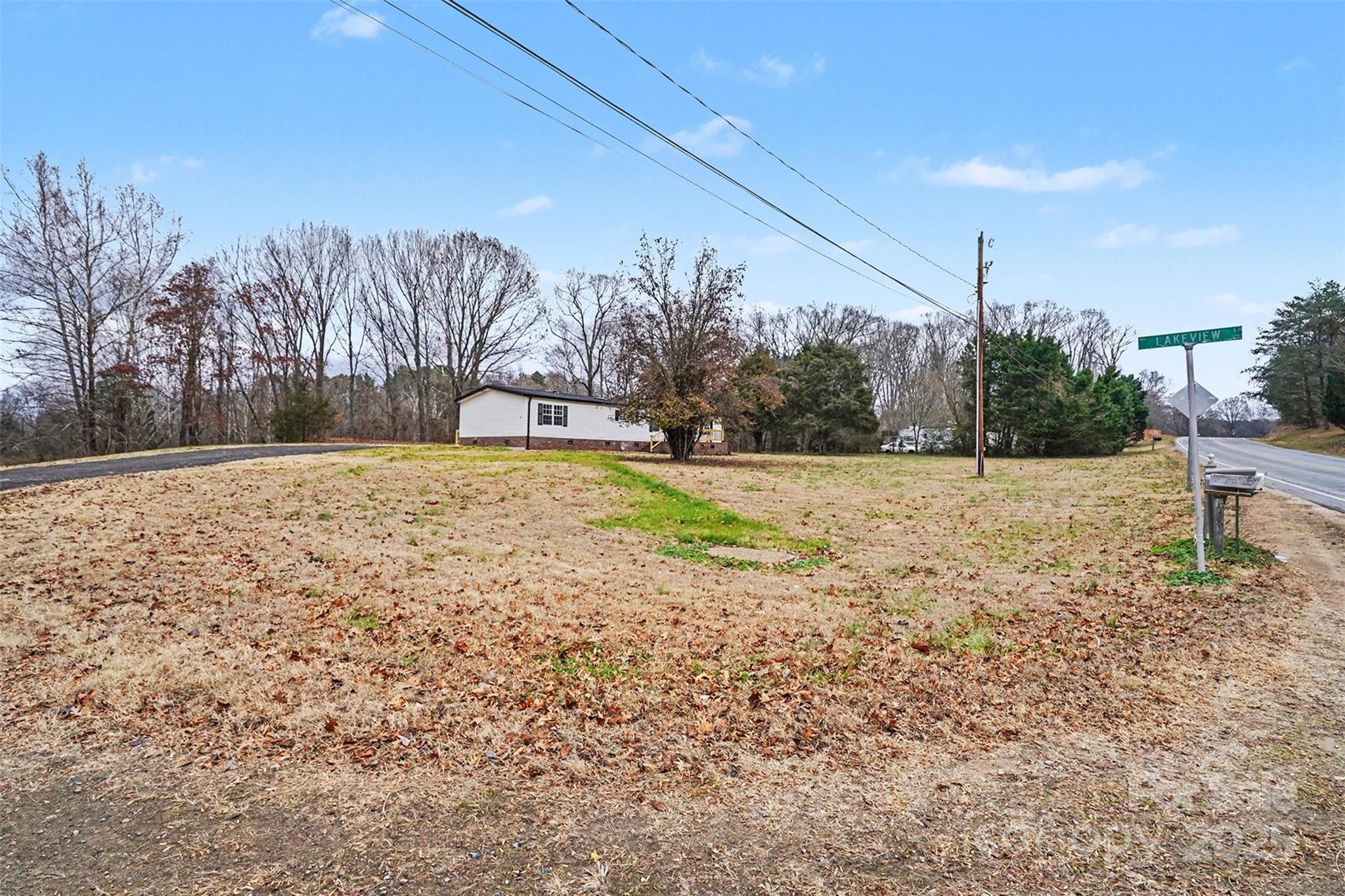 115 Lakeview Lane China Grove, NC 28023 - Photo 4 of 32 a view of a yard with trees in the background