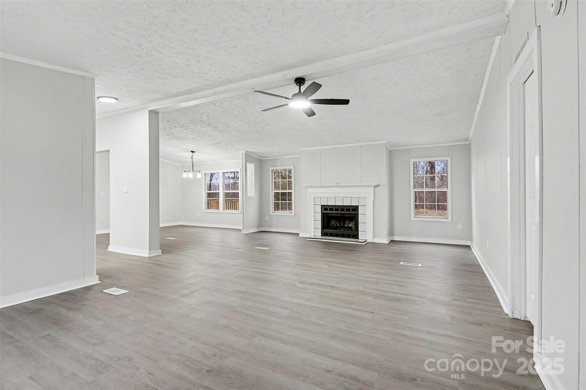 115 Lakeview Lane China Grove, NC 28023 - Photo 5 of 32 wooden floor in an empty room with a fireplace