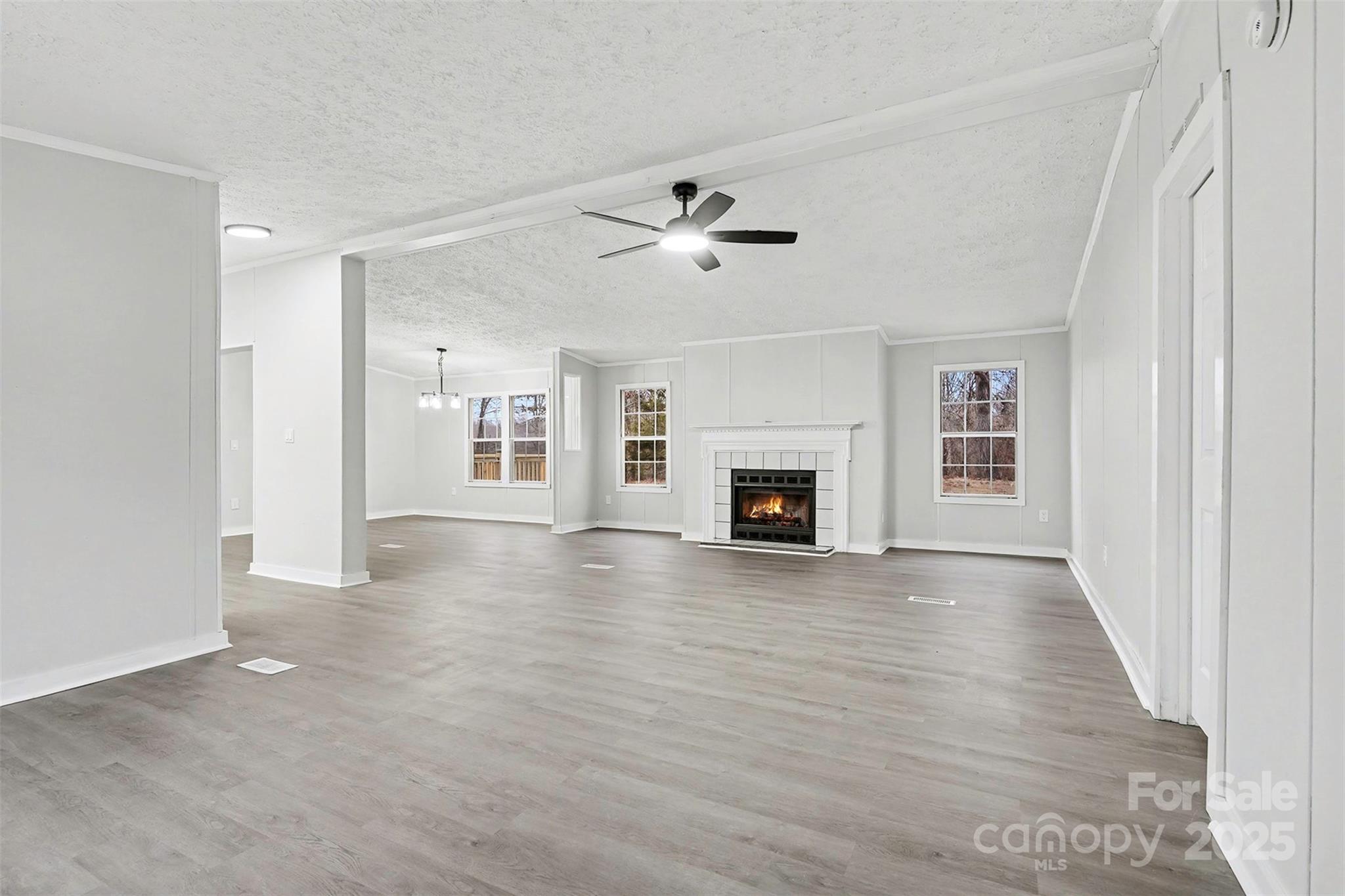 115 Lakeview Lane China Grove, NC 28023 - Photo 6 of 32 wooden floor in an empty room with a fireplace