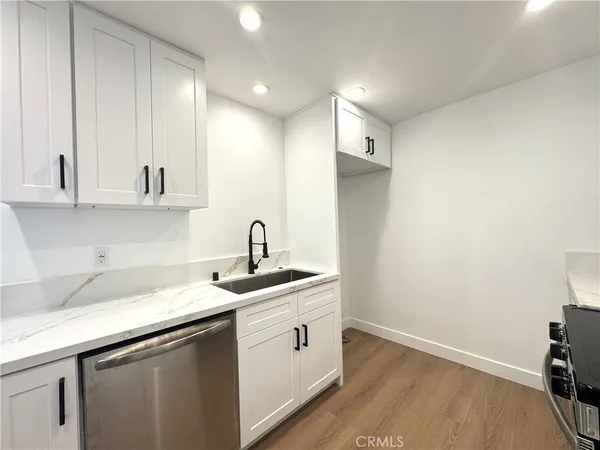 a kitchen that has a sink and a stove in it