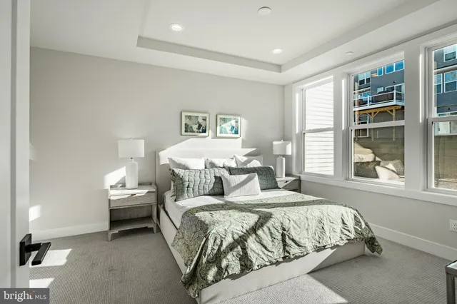 a living room with furniture and a white bed