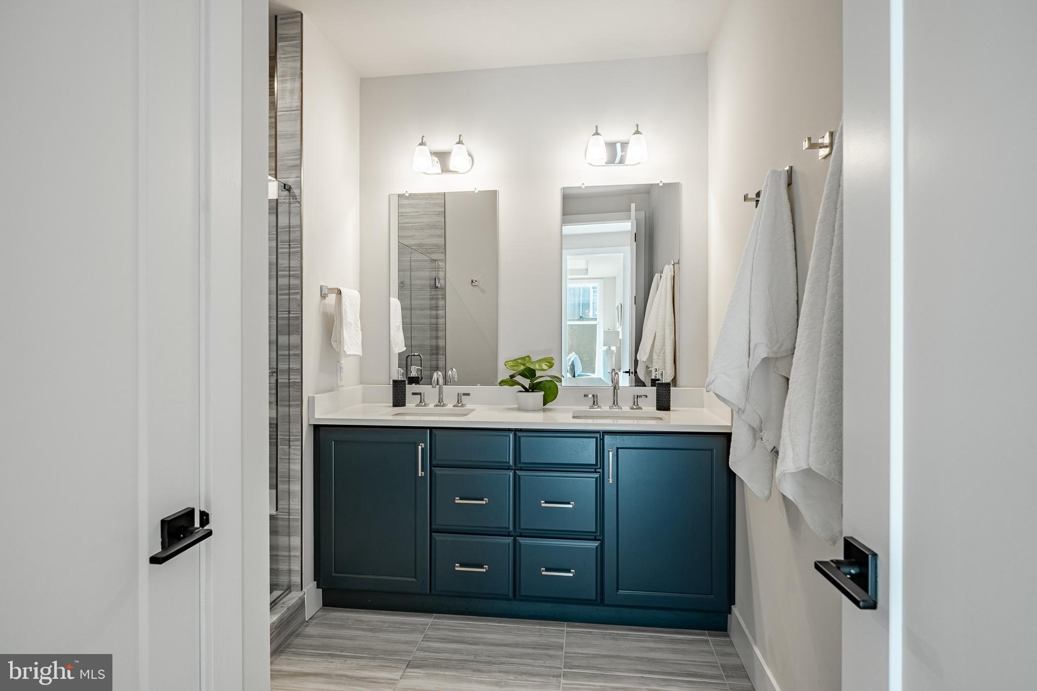 581 Trifecta Road Downingtown, PA 19335 - Photo 22 of 45 a bathroom with a double vanity sink and mirror with shower