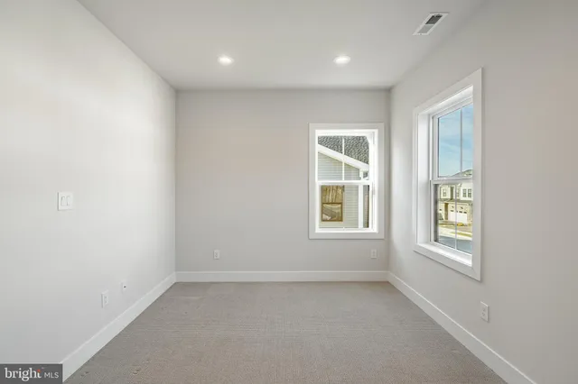 an empty room with windows and closet