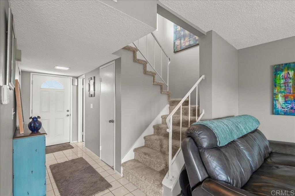 3047 Highlands Boulevard Spring Valley, CA 91977 - Photo 21 of 39 a living room with furniture and stairs