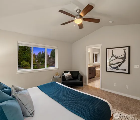 a bedroom with furniture and a large window