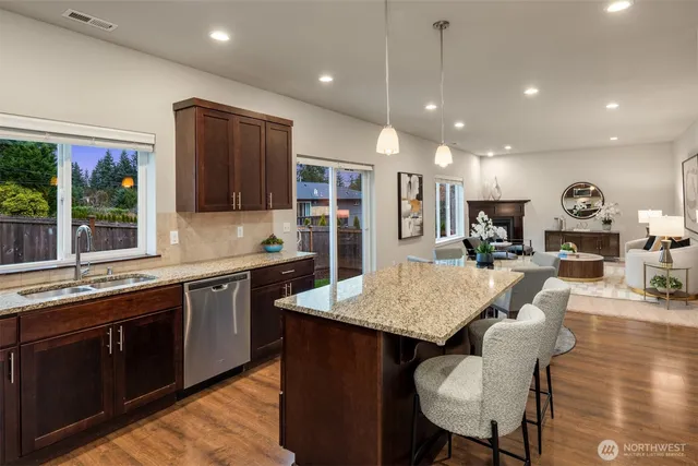 a large kitchen with kitchen island a large island in it