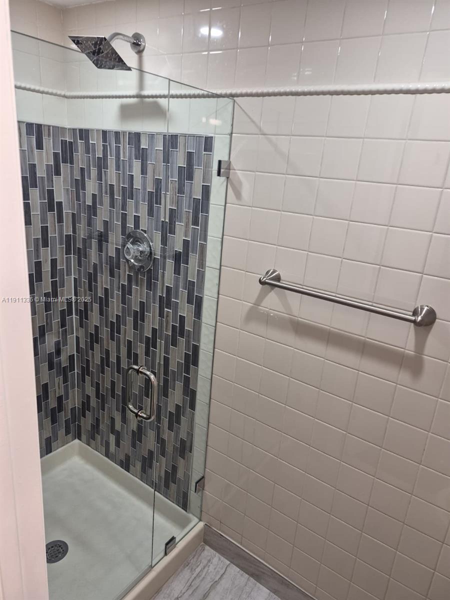 116 Northwest 60th Avenue, Unit 11 Margate, FL 33063 - Photo 15 of 18 a bathroom with a shower