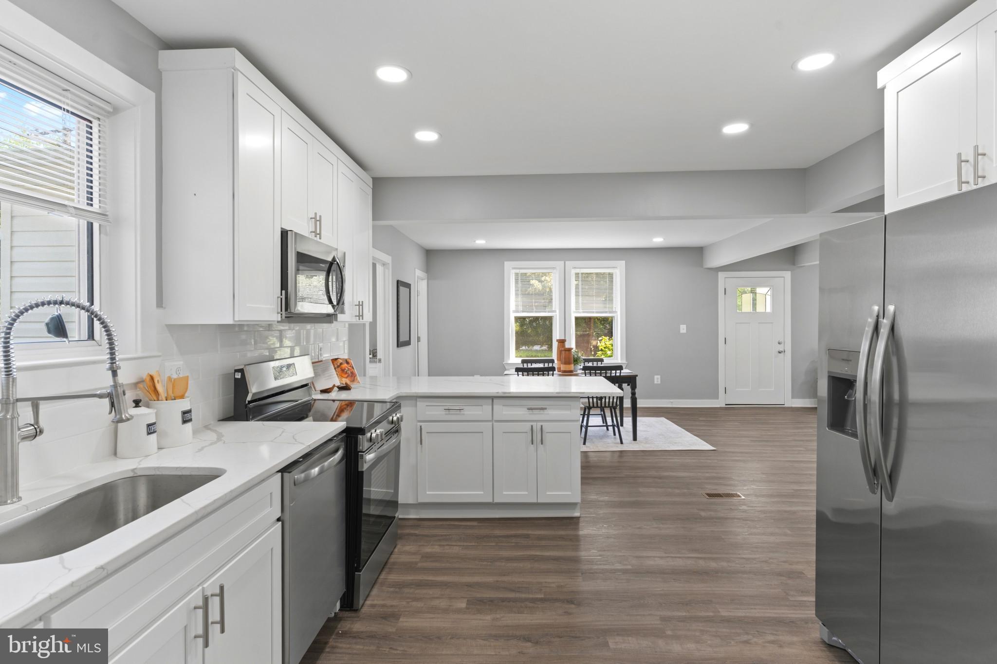5728 Clover Road Baltimore, MD 21215 - Photo 12 of 40 a kitchen with a sink cabinets and stainless steel appliances