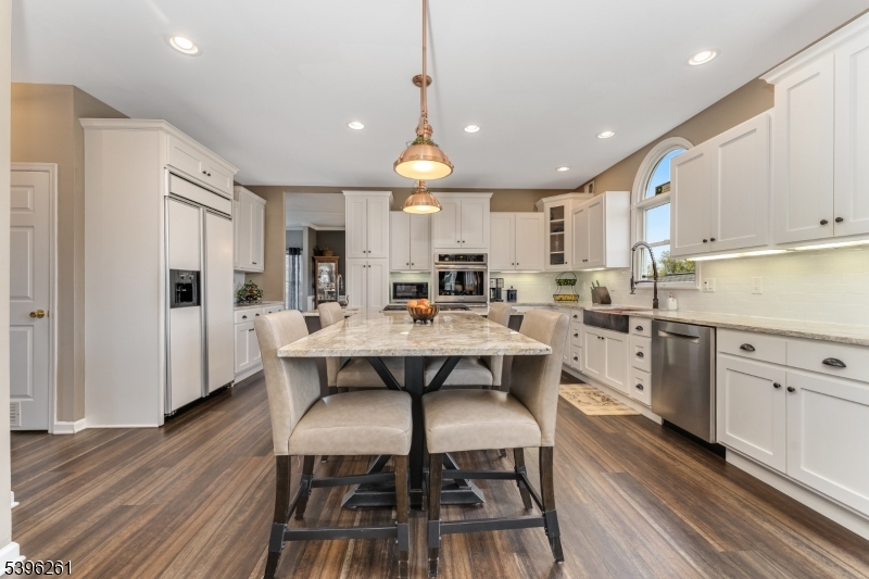 7 Maple Springs Road Pittstown, NJ 08867 - Photo 19 of 41 a kitchen with stainless steel appliances a dining table chairs stove and sink