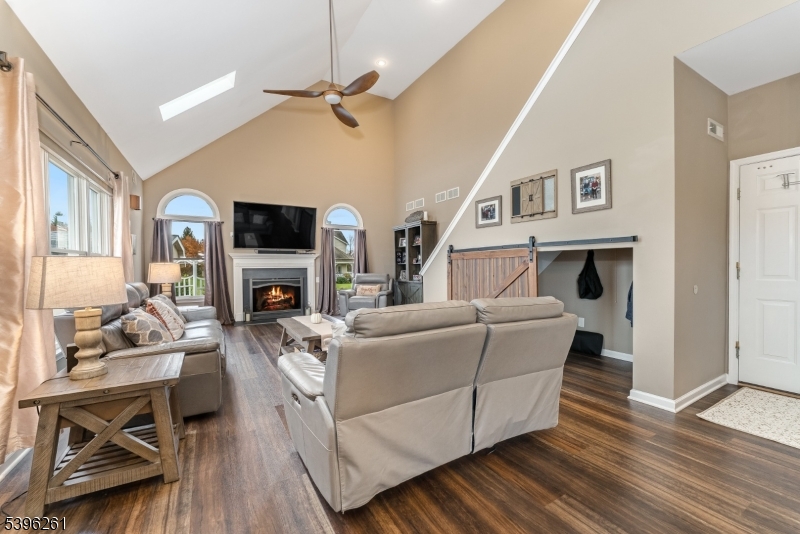 7 Maple Springs Road Pittstown, NJ 08867 - Photo 23 of 41 a living room with furniture a fireplace and a flat screen tv