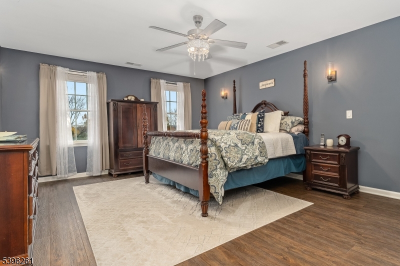 7 Maple Springs Road Pittstown, NJ 08867 - Photo 27 of 41 a bed room with a bed and a chandelier